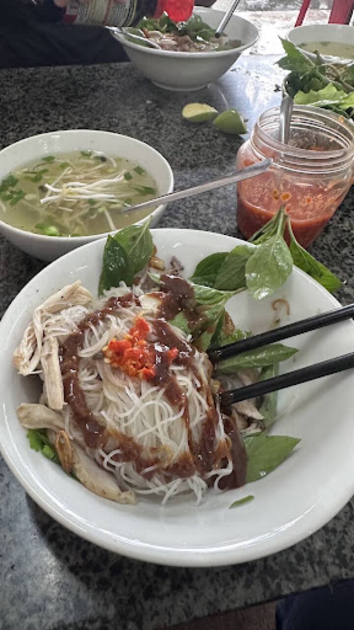 Tô bún gà trộn sốt với ớt, rau thơm, kèm bát nước dùng tại Phở Ngọc Sơn